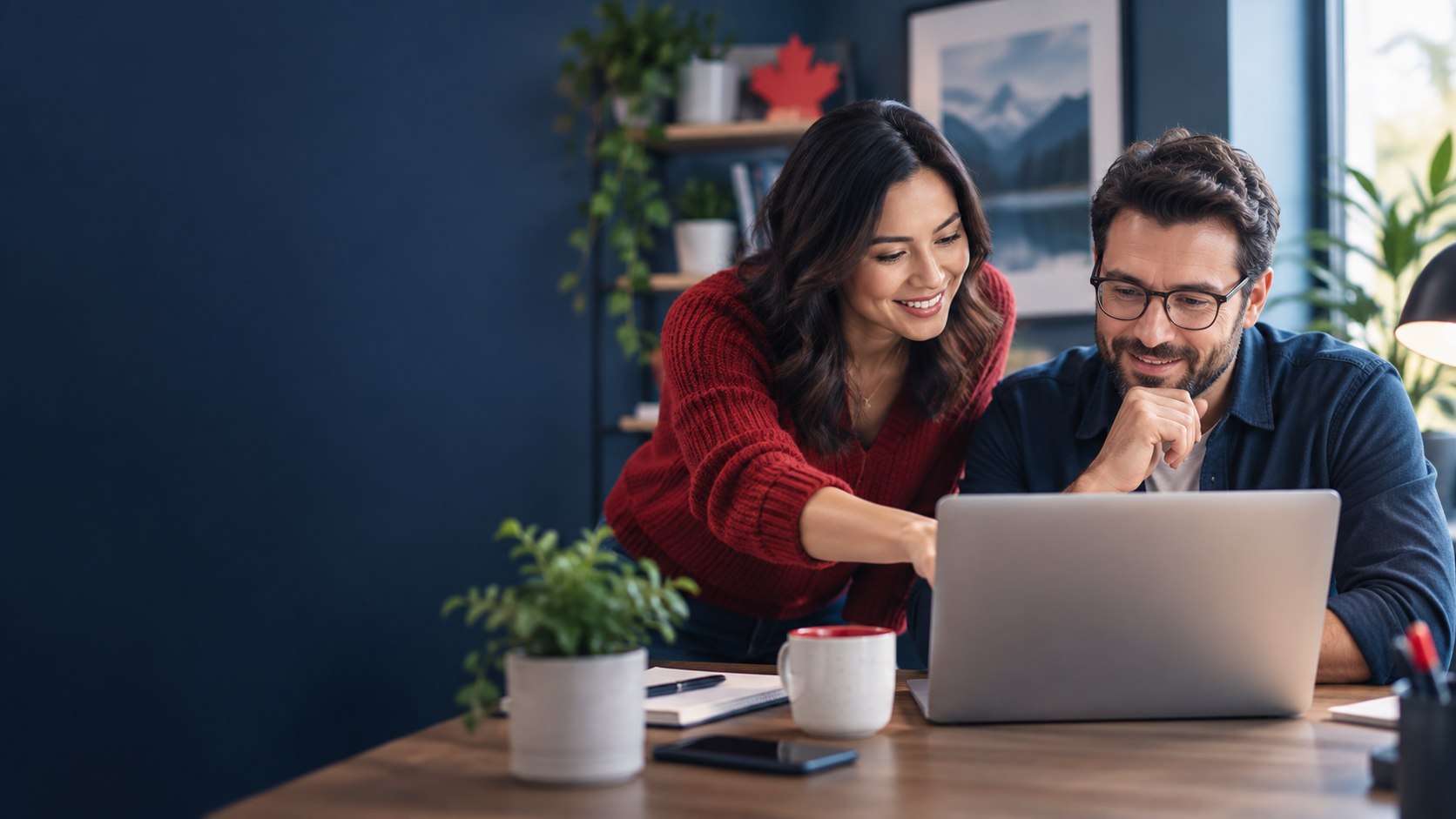 Two Canadian small-business colleagues reviewing software options on a laptop